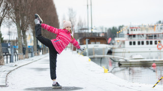 Tyttö liikkumassa talvisessa kaupunkimaisemassa.
